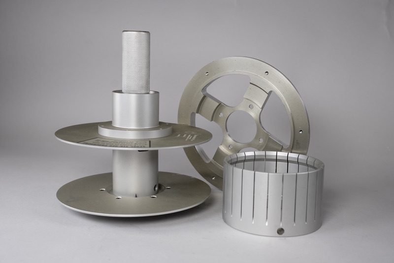 Precision-machined aluminum spools, a spoked wheel and a slotted sleeve